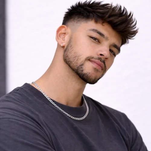 French crop blowout taper haircut for men with voluminous textured top, clean taper fade sides and modern stylish look