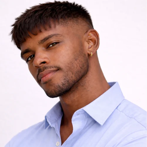 Trendy French crop fade hairstyle for men featuring short fringe, sharp fade and clean beard look