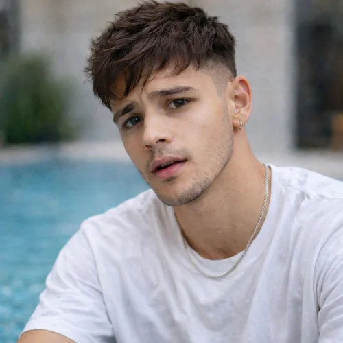 messy textured french crop haircut on young man with relaxed natural style