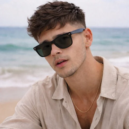 thick hair textured french crop haircut on young man at beach wearing sunglasses