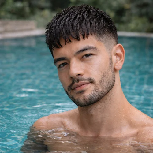 thick fringe french crop haircut for men with textured front and stylish modern look at swimming pool