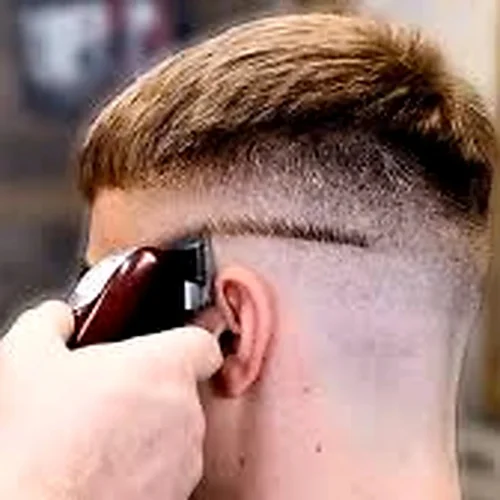 french crop fade haircut with textured fringe and clean fade created by barber using hair clipper modern mens hairstyle